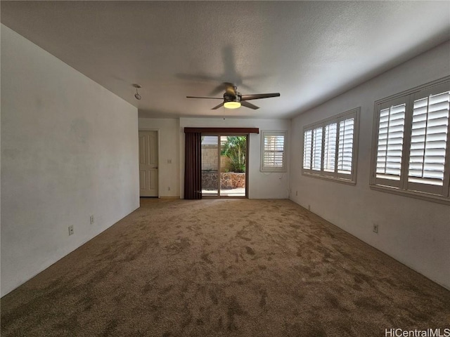 unfurnished living room featuring carpet, ceiling fan, and a textured ceiling