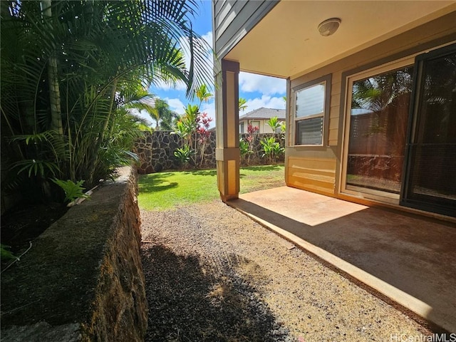 view of yard featuring fence and a patio