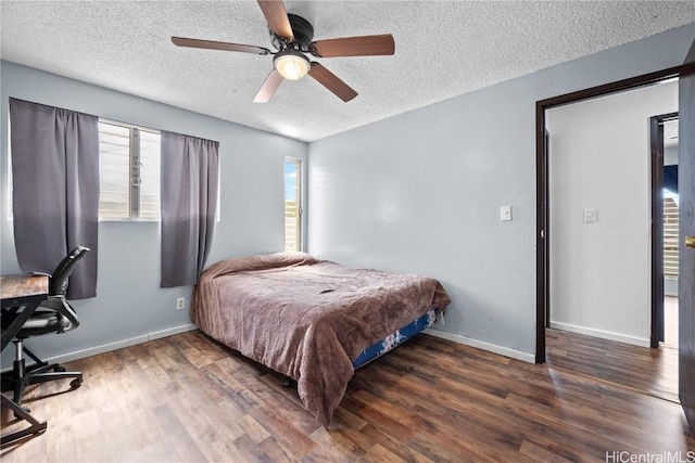 bedroom with a textured ceiling, wood finished floors, a ceiling fan, and baseboards