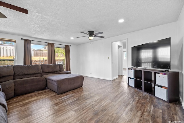 living room with recessed lighting, a ceiling fan, a textured ceiling, and wood finished floors