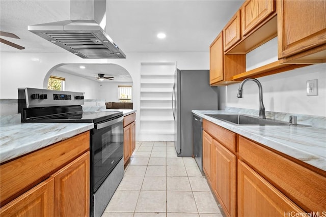 kitchen with range with electric stovetop, light tile patterned floors, a ceiling fan, a sink, and wall chimney exhaust hood