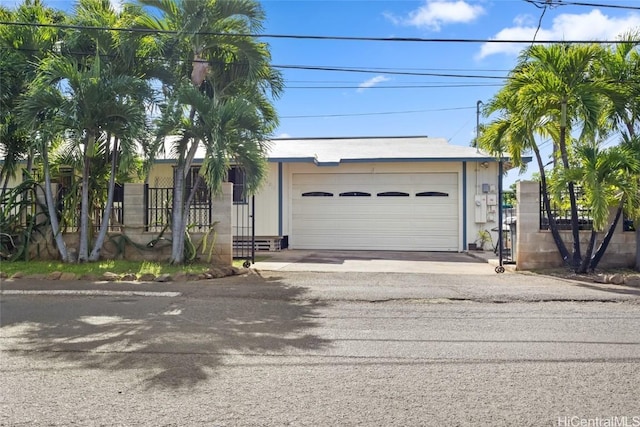 view of front of property featuring a garage and fence