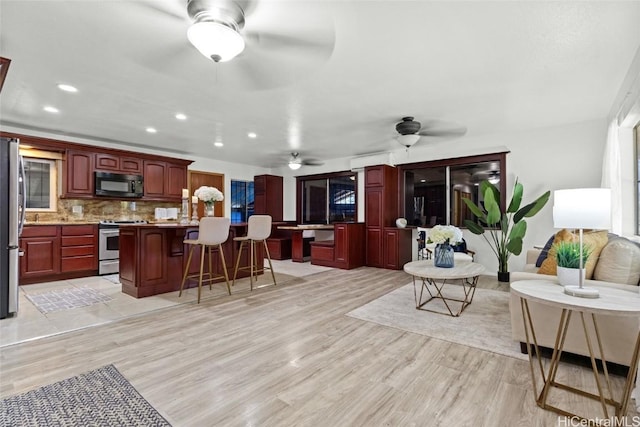 interior space featuring recessed lighting, light wood-style floors, and ceiling fan