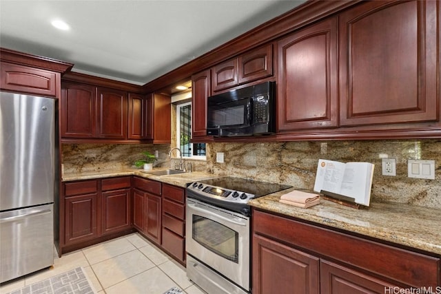 kitchen with a sink, light tile patterned floors, reddish brown cabinets, and stainless steel appliances