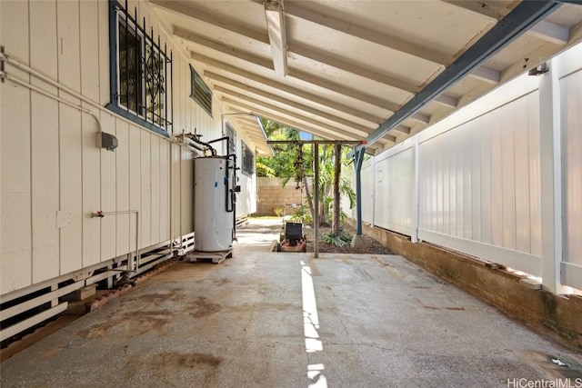 view of patio featuring fence and water heater