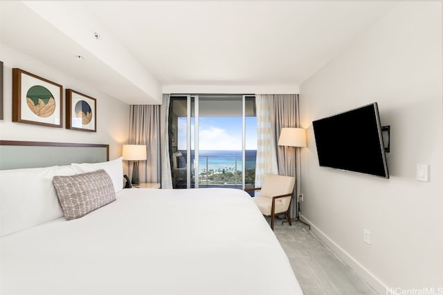 bedroom featuring access to exterior, light colored carpet, and baseboards