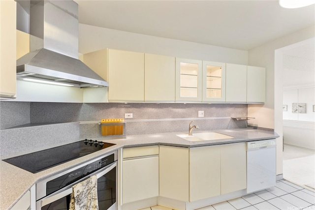 531 Hahaione St Unit 2-9A, Honolulu, HI 96825 - kitchen featuring oven, dishwasher, a sink, wall chimney range hood, and cream cabinetry