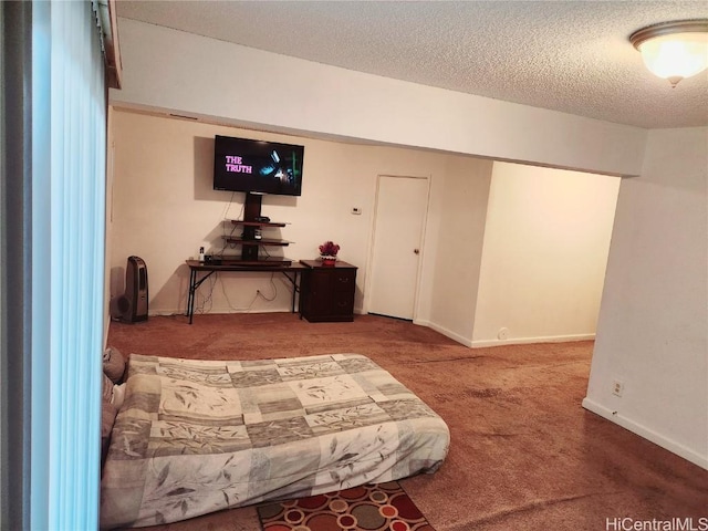 carpeted bedroom featuring a textured ceiling and baseboards