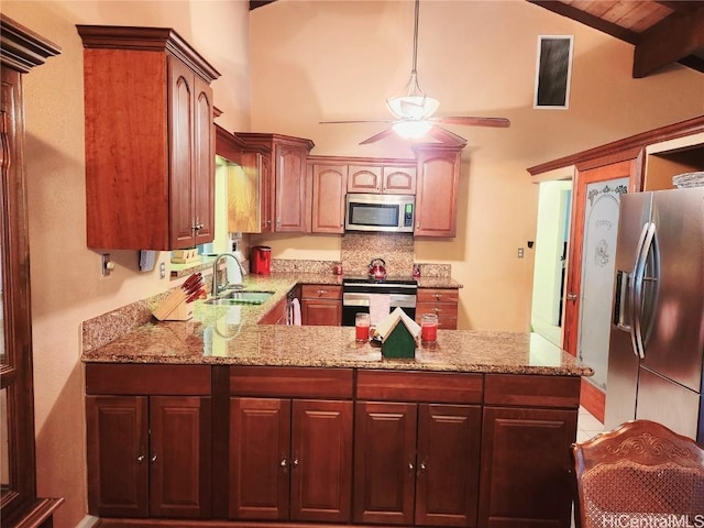 kitchen featuring ceiling fan, light stone counters, a peninsula, stainless steel appliances, and a sink