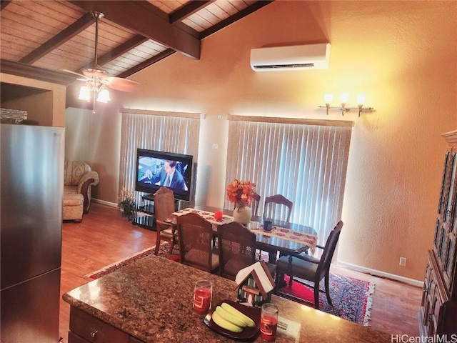 dining room with lofted ceiling with beams, a wall unit AC, wood finished floors, wood ceiling, and baseboards