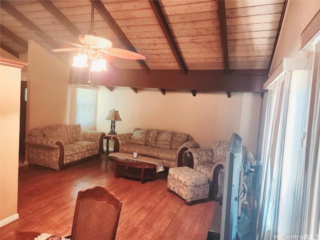 living area featuring vaulted ceiling with beams, wooden ceiling, wood finished floors, and a ceiling fan