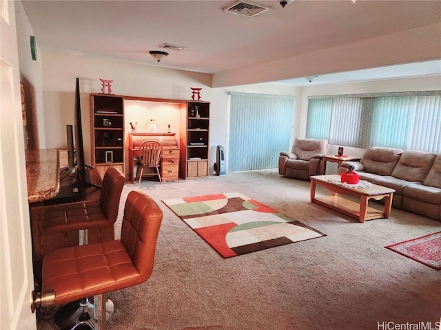 living area with carpet flooring and visible vents