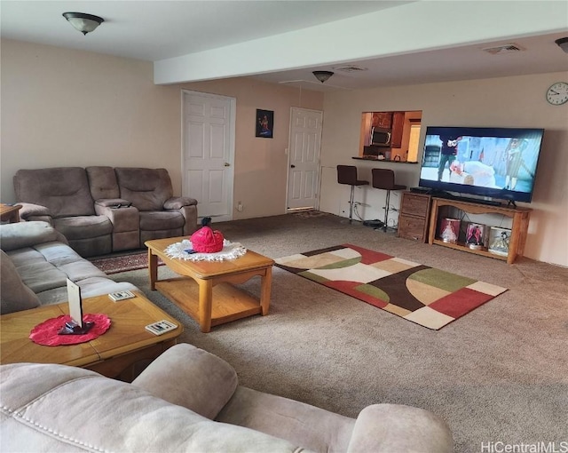 carpeted living area featuring visible vents