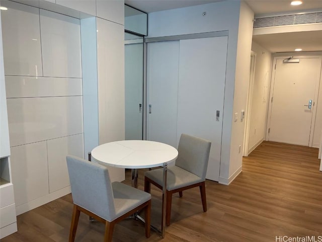 dining space featuring recessed lighting, visible vents, and wood finished floors