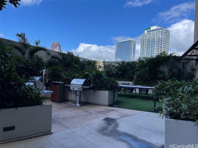 view of patio featuring a grill and a view of city