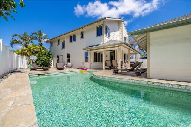 back of house featuring ceiling fan, a patio, a fenced backyard, and a fenced in pool