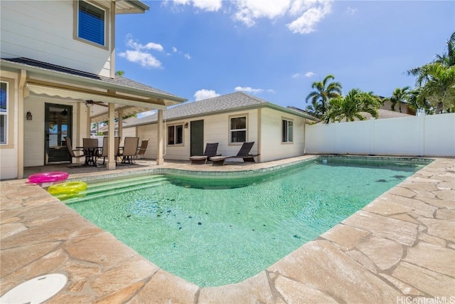 view of pool featuring a fenced in pool, fence, a ceiling fan, and a patio