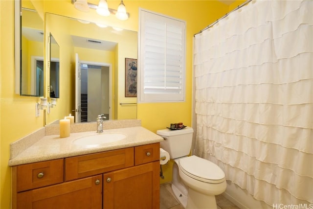 bathroom with toilet, a shower with shower curtain, vanity, and visible vents