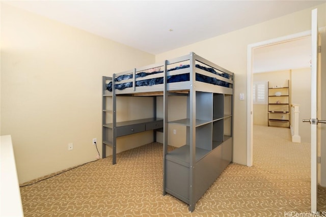 bedroom featuring light carpet