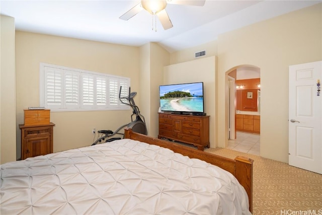 bedroom with visible vents, arched walkways, lofted ceiling, ceiling fan, and tile patterned flooring