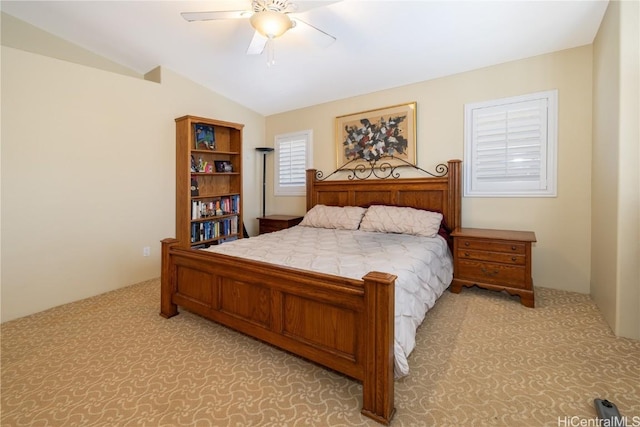 bedroom featuring light colored carpet, vaulted ceiling, and ceiling fan