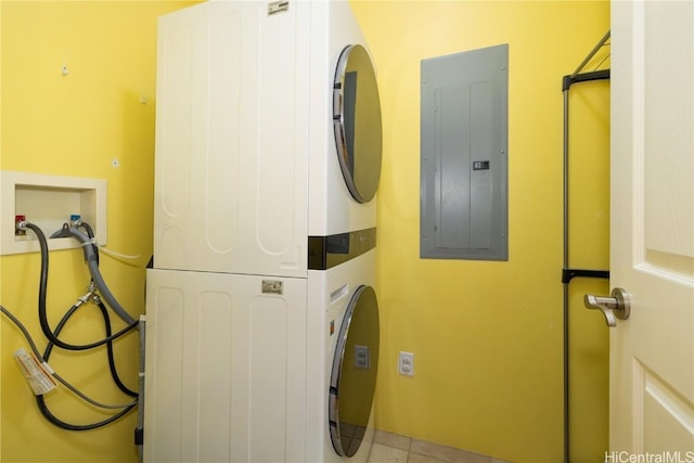 laundry room with laundry area, electric panel, and stacked washing maching and dryer