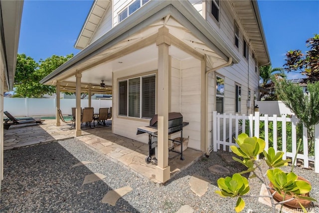 view of patio with fence private yard, outdoor dining area, a ceiling fan, and area for grilling