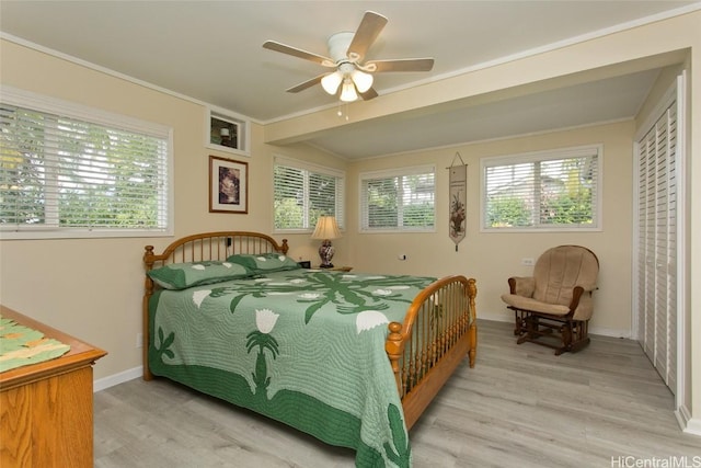 bedroom featuring a ceiling fan, baseboards, and light wood finished floors