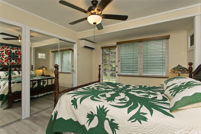 bedroom with wood finished floors, ornamental molding, a ceiling fan, and a wall mounted AC