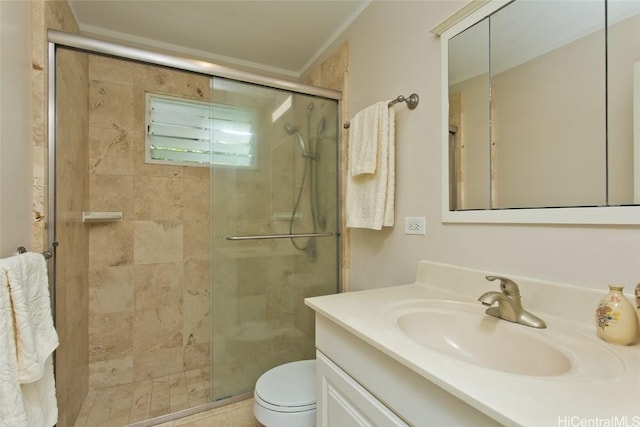 bathroom featuring a stall shower, toilet, and vanity