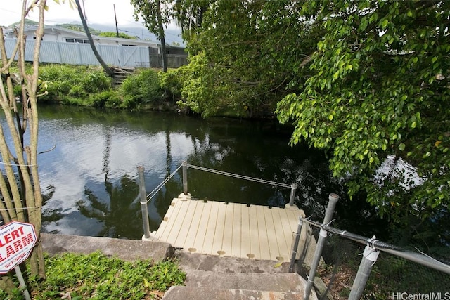 dock area featuring a water view and fence