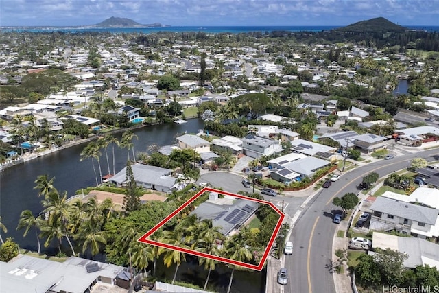 drone / aerial view featuring a residential view and a water and mountain view