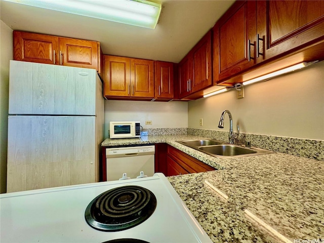 3130 Ala Ilima St Unit 18C, Honolulu, HI 96818 - kitchen featuring white appliances, light countertops, and brown cabinetry