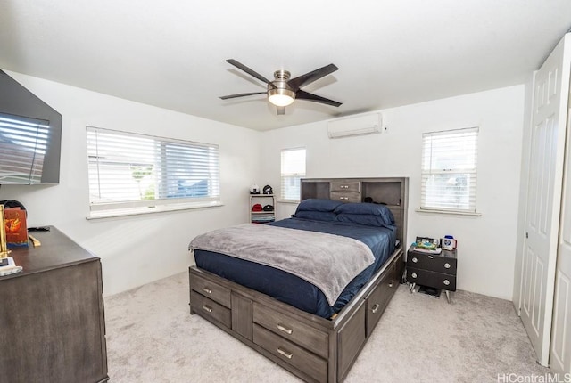 bedroom featuring light carpet, ceiling fan, and a wall mounted AC