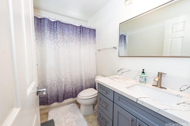 full bath featuring tile patterned flooring, vanity, and toilet