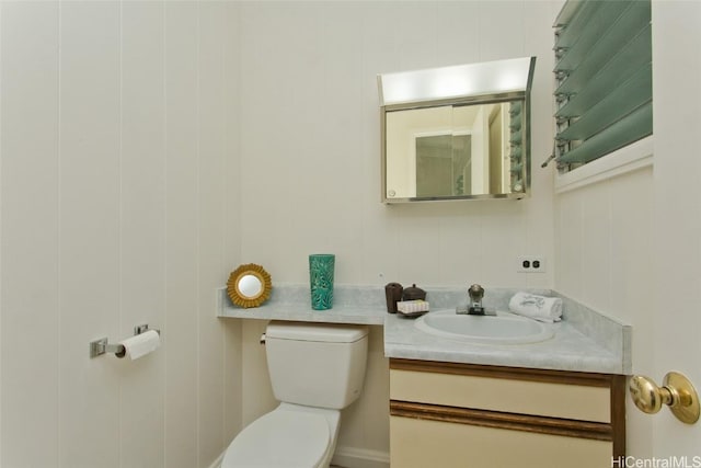 half bathroom with toilet and vanity