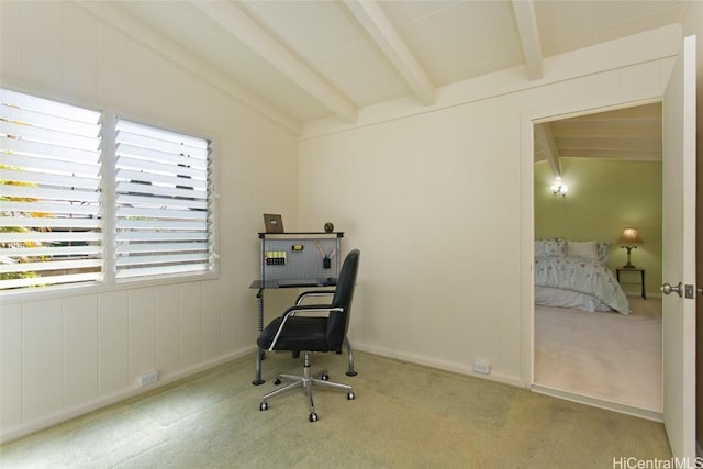 carpeted office space featuring lofted ceiling with beams