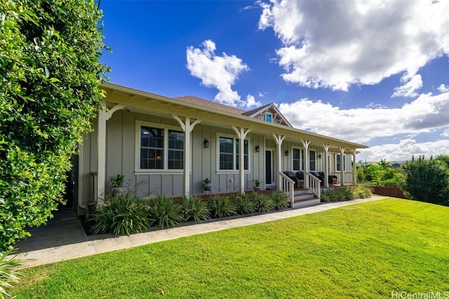 view of front of house with a porch, board and batten siding, and a front yard