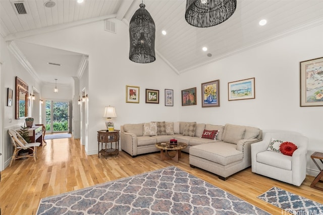 living room with beam ceiling, wood finished floors, visible vents, and ornamental molding