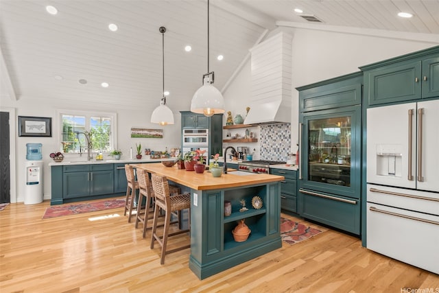 kitchen with white appliances, open shelves, butcher block countertops, and green cabinetry