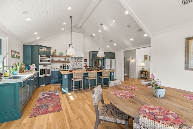 dining space featuring visible vents, beamed ceiling, wood ceiling, light wood-type flooring, and high vaulted ceiling