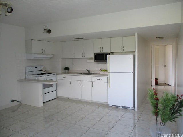 kitchen featuring white appliances, white cabinets, light countertops, under cabinet range hood, and a sink