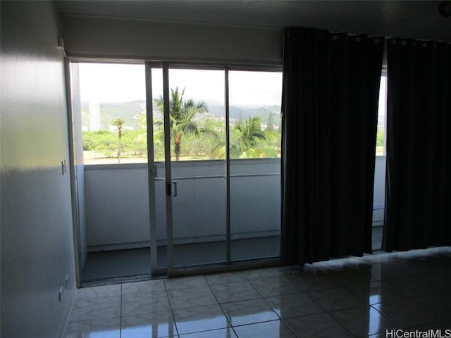 doorway with light tile patterned flooring and a mountain view