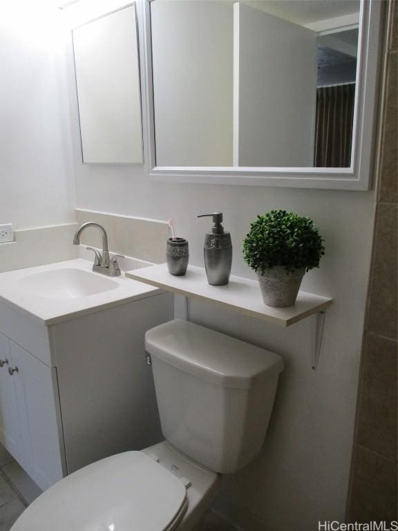 bathroom featuring toilet and vanity