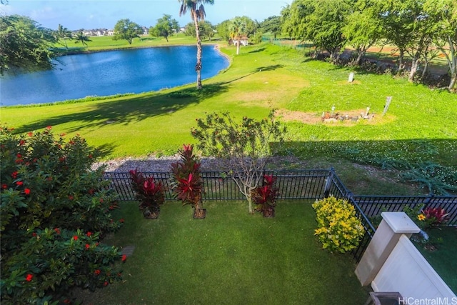 exterior space with a water view and fence