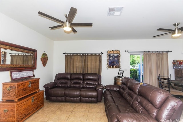 living area featuring light tile patterned floors, visible vents, and a ceiling fan