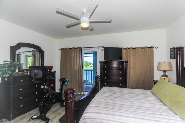 bedroom with access to outside, multiple windows, ceiling fan, and wood finished floors