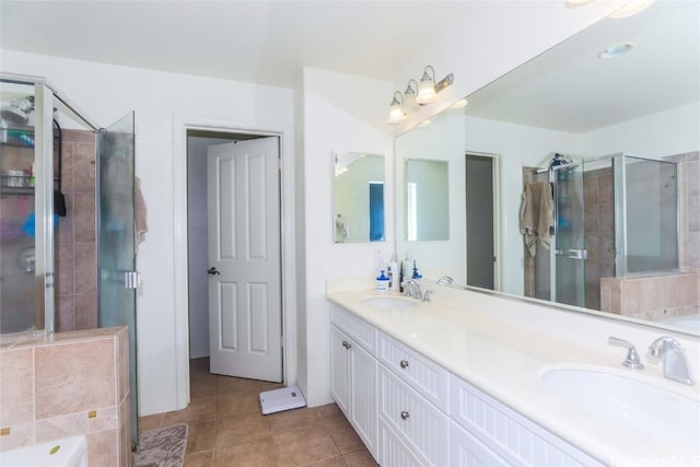 bathroom with a stall shower, a sink, and tile patterned floors