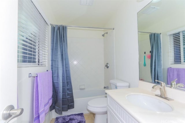 full bathroom with tile patterned flooring, vanity, toilet, and shower / bath combo with shower curtain