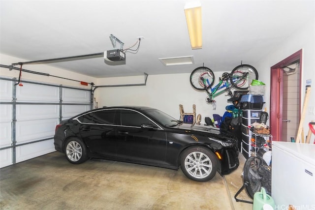 garage featuring a garage door opener and fridge